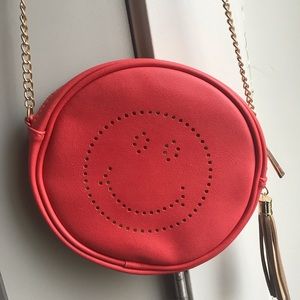 Cute little smiley gold and pink cross body purse.